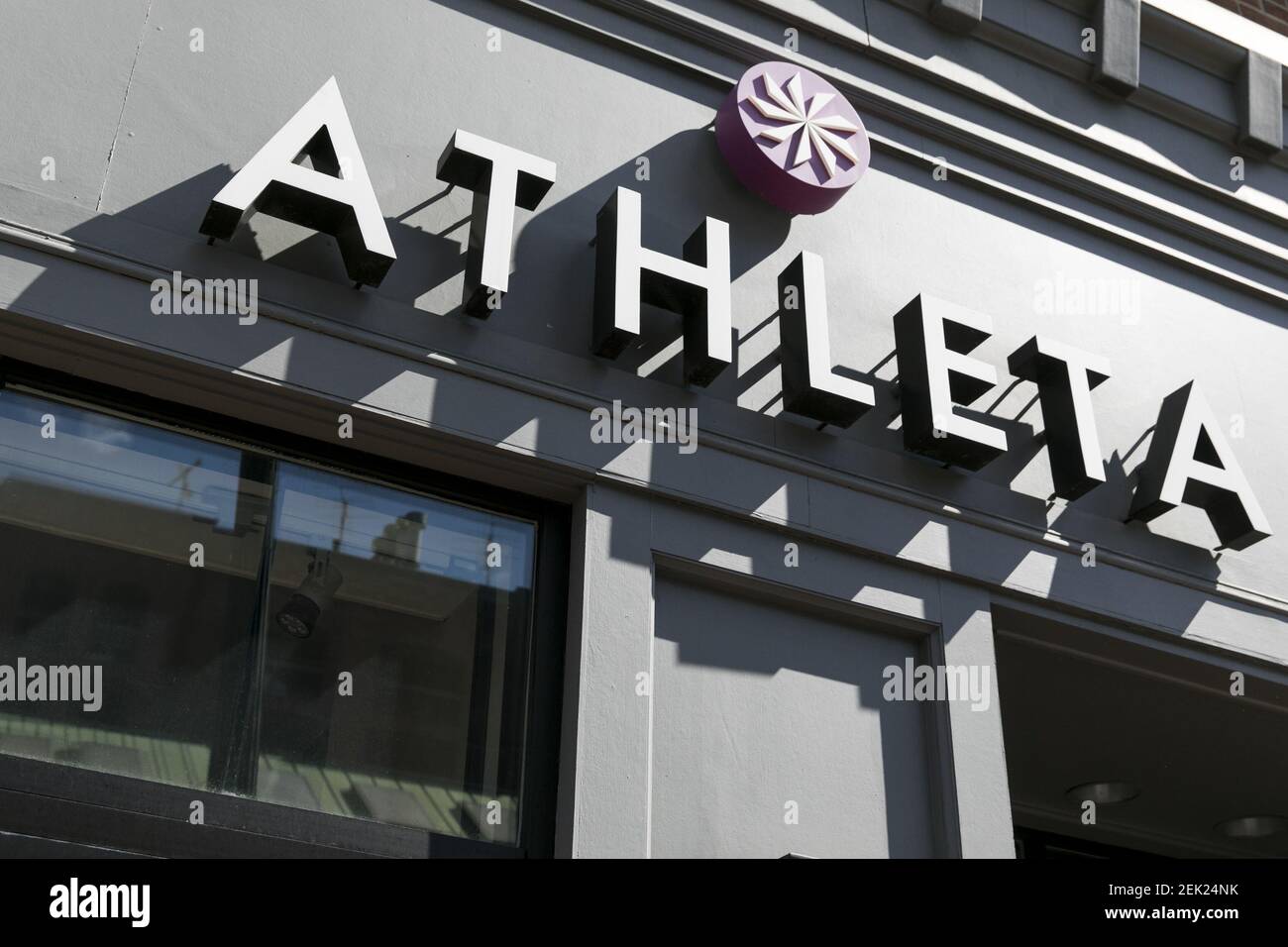 A logo sign outside of a Athleta retail store location in Washington, D