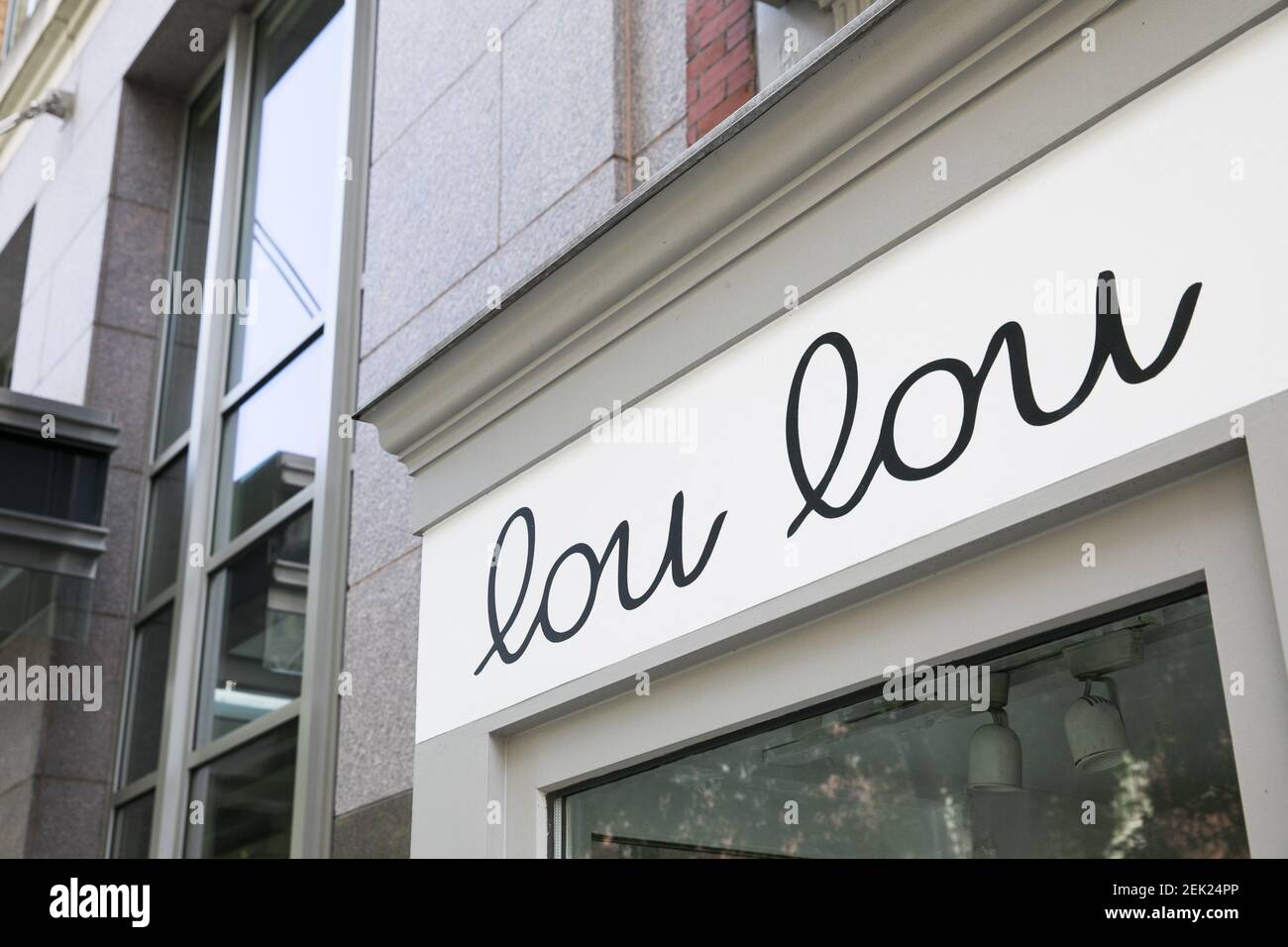 A logo sign outside of a Lou Lou Boutiques retail store location in ...