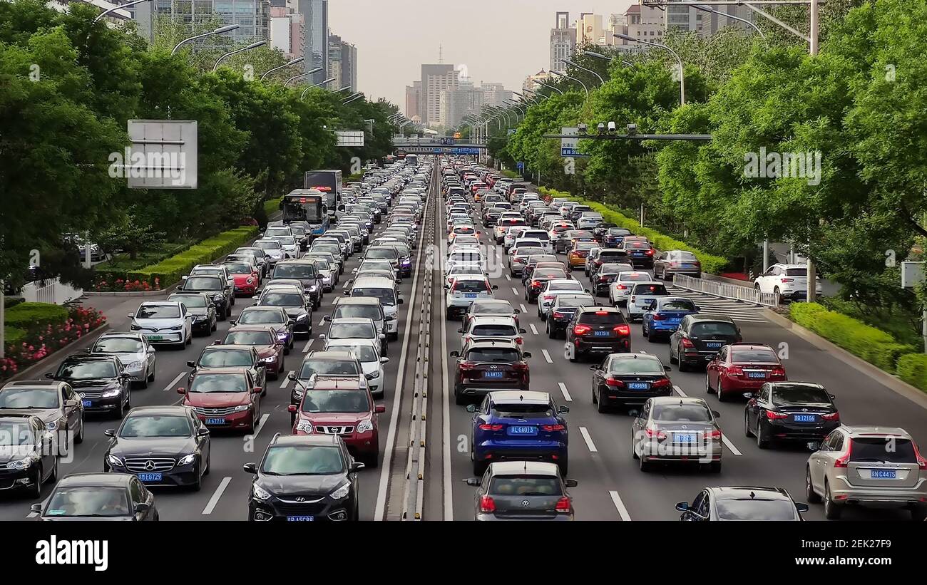 Traffic stream composed of various vehicles moves slowly during the
