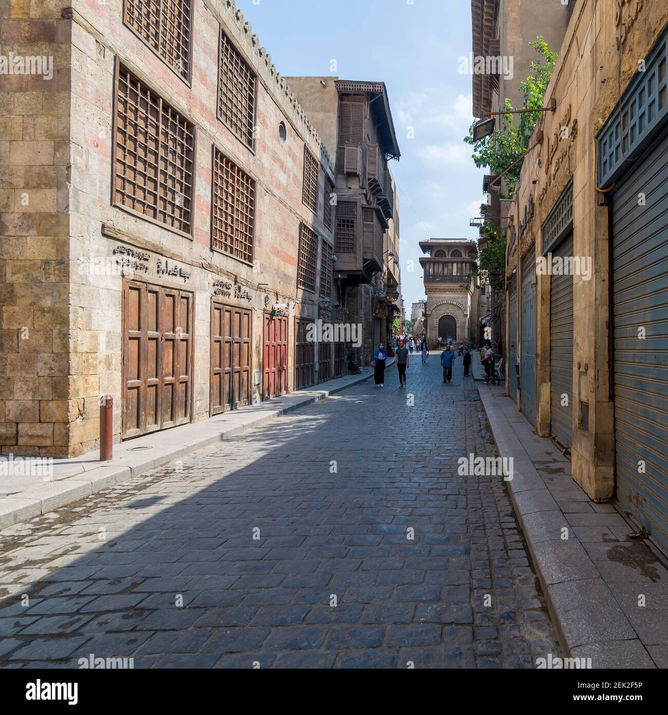 Cairo, Egypt- June 26 2020: Moez Street with few local visitors and Sabil-Kuttab of Katkhuda Mamluk era historic building at the far end during Covid-19 lockdown period, Gamalia district, Old Cairo Stock Photo