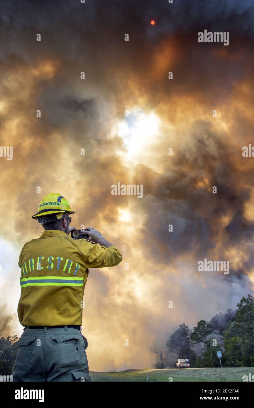 May 6, 2020; Milton, FL, USA; Forest Service public information officer Joe Zwierzchowski snaps a photo of the Five Mile Swamp Fire in Milton, Florida on Wednesday, May 6, 2020. Mandatory Credit: Gregg Pachkowski/Pensacola News Journal via USA TODAY NETWORK/Sipa USA Stock Photo