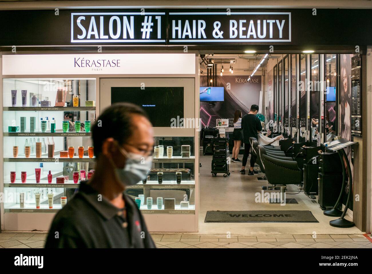 A man walks past a hair salon while wearing a face mask as a preventive measure during the Coronavirus (COVID-19) crisis. Singapore has so far confirmed 26,773 coronavirus cases, 21 deaths and A man walks past a hair salon while wearing a face mask as a preventive measure during the Coronavirus (COVID-19) crisis. Singapore has so far confirmed 26,773 coronavirus cases, 21 deaths and