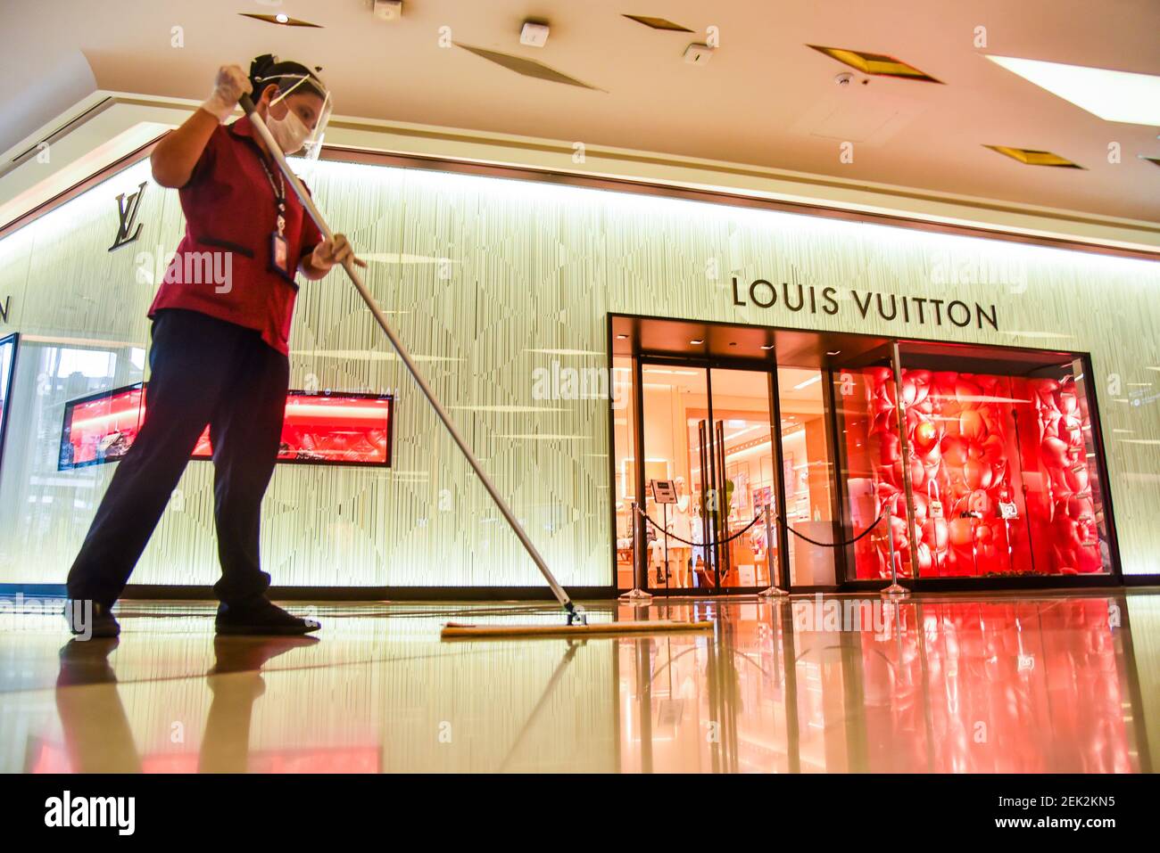 A staff member of Siam Paragon shopping mall wearing a face shield