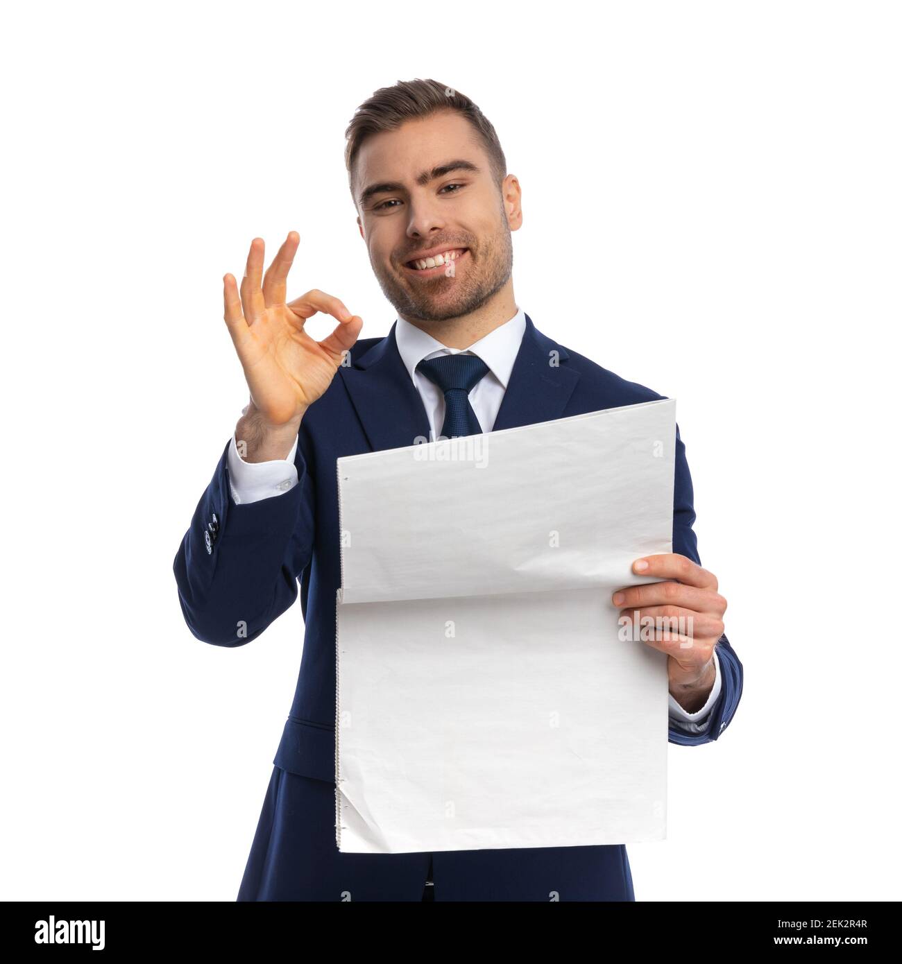 Smiling Young Guy In Navy Blue Suit Reading Newspaper Holding Hand Up And Making Ok Sign Standing And Posing Isolated On White Background Portrait Stock Photo Alamy