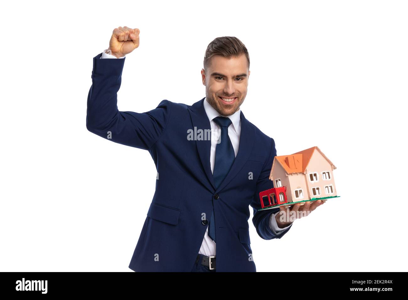 elegant real estate agent in navy blue suit holding fist in the air and ...