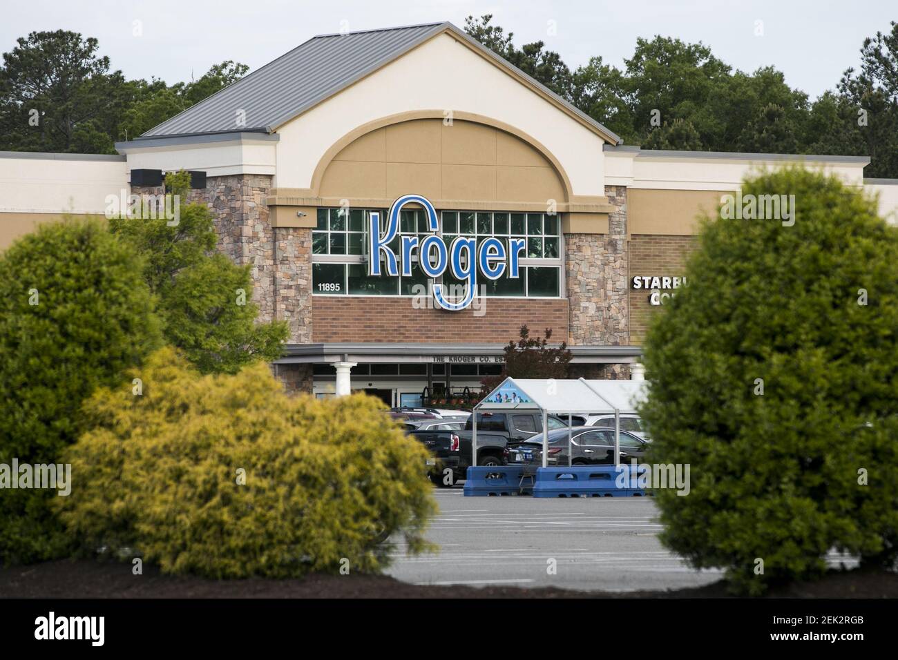 A logo sign outside of a Kroger retail grocery store location in