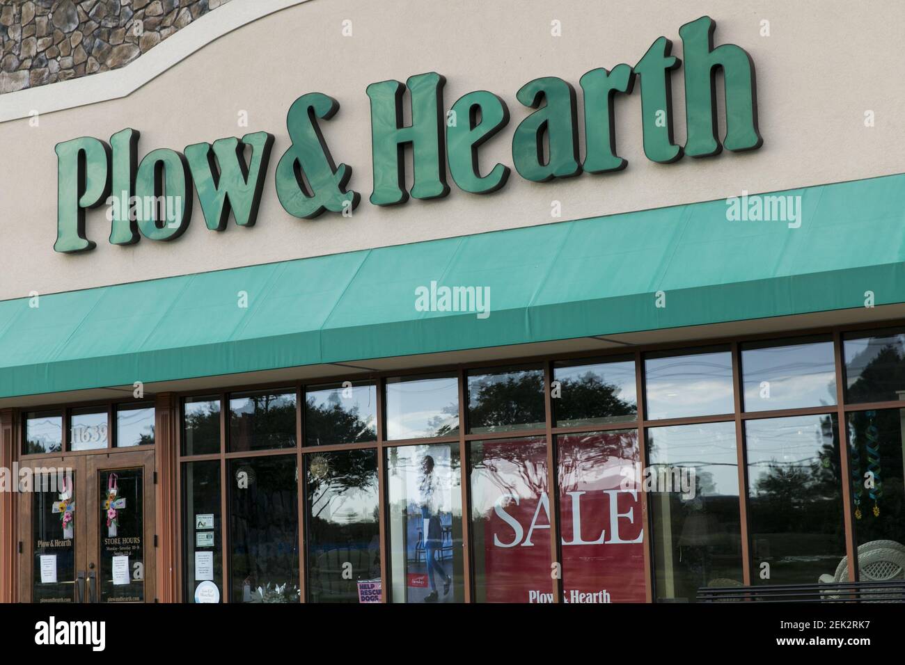 A logo sign outside of a Plow & Hearth retail store location in