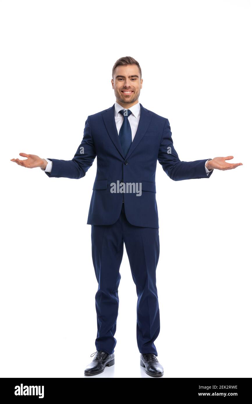 happy businessman in navy blue suit opening arms and smiling, standing ...