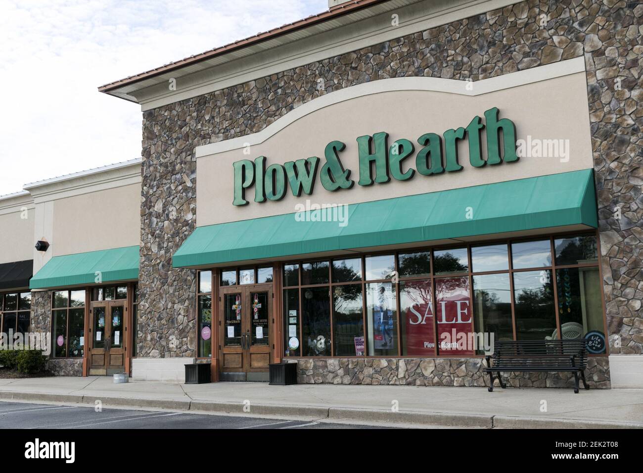 A logo sign outside of a Plow & Hearth retail store location in