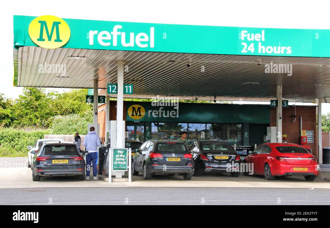 Cars queue for petrol at a Morrisons petrol station selling unleaded