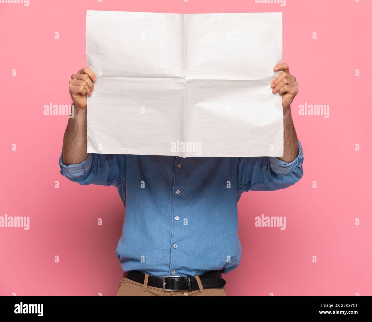 Portrait Of Young Casual Guy In Denim Shirt Covering Face With Newspaper Standing And Posing On Pink Background In Studio Stock Photo Alamy Portrait Of Young Casual Guy In Denim Shirt Covering Face With Newspaper Standing And Posing On Pink Background In Studio Stock Photo Alamy