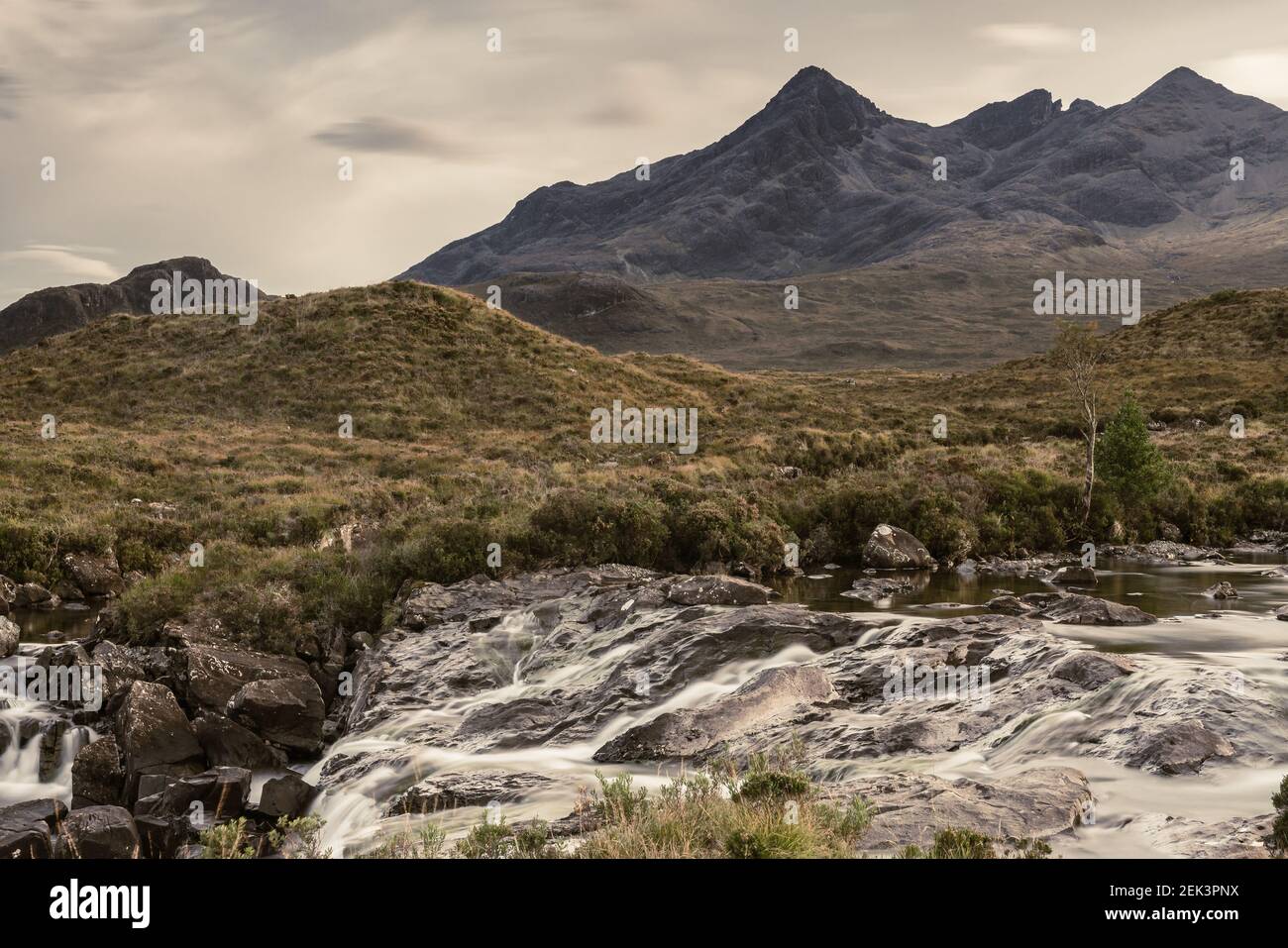 Scenic view of a highland's landscape with mountains and a stream Stock ...