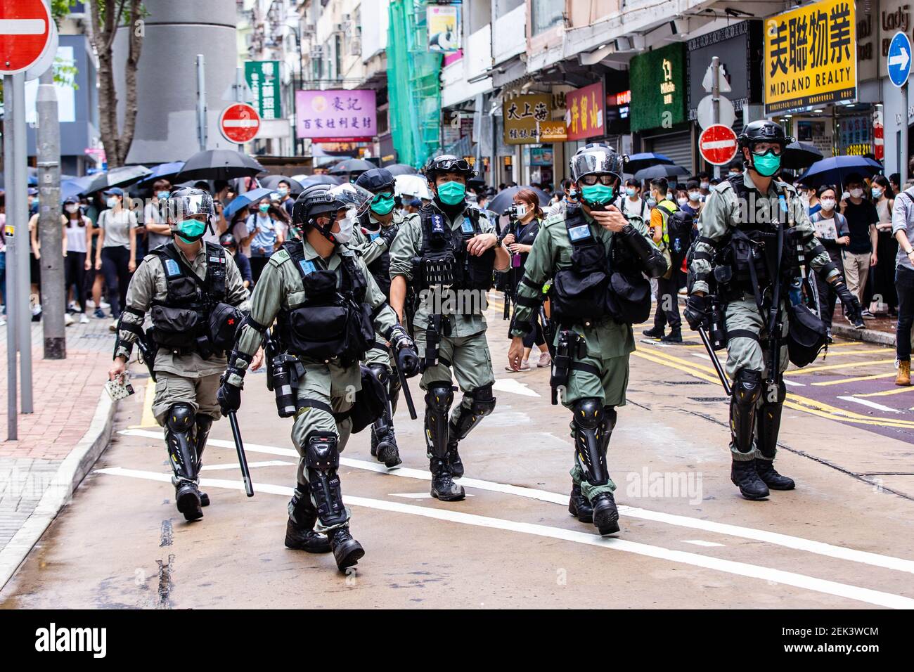 Riot police officers patrolling the streets during the demonstration.  Protesting against a bill that would criminalise insulting the Chinese  national anthem, demonstrators marched on the streets and chanted songs and  slogans. Later,