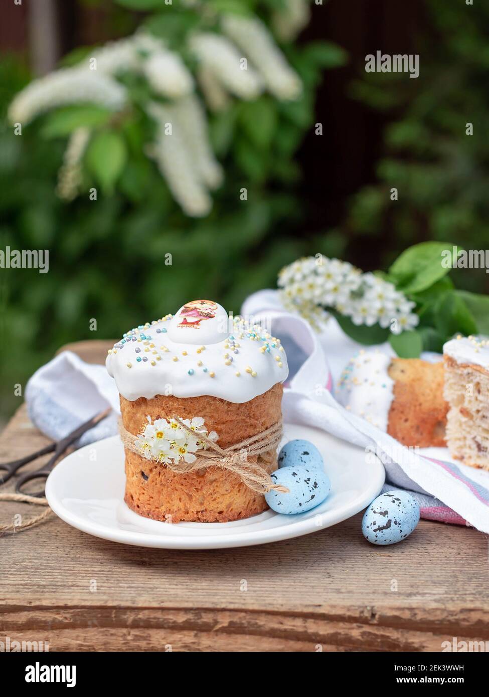 Easter composition with Easter cake, Kulich on background of flowering branches Stock Photo