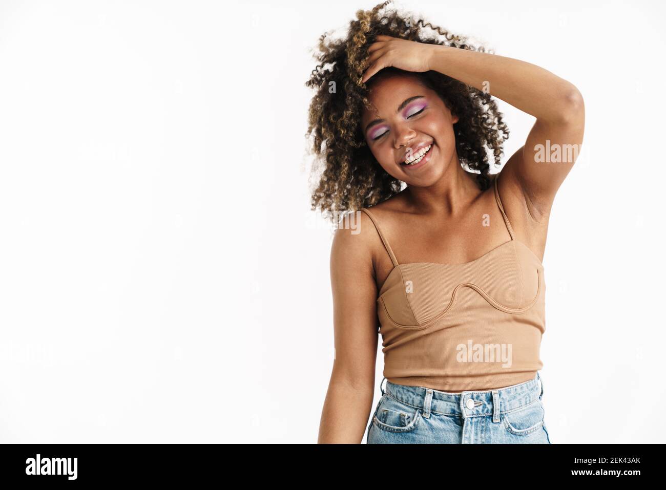 Joyful african american girl with piercing laughing at camera isolated ...