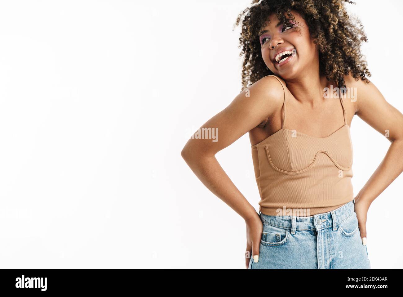 Joyful african american girl with piercing laughing at camera isolated ...