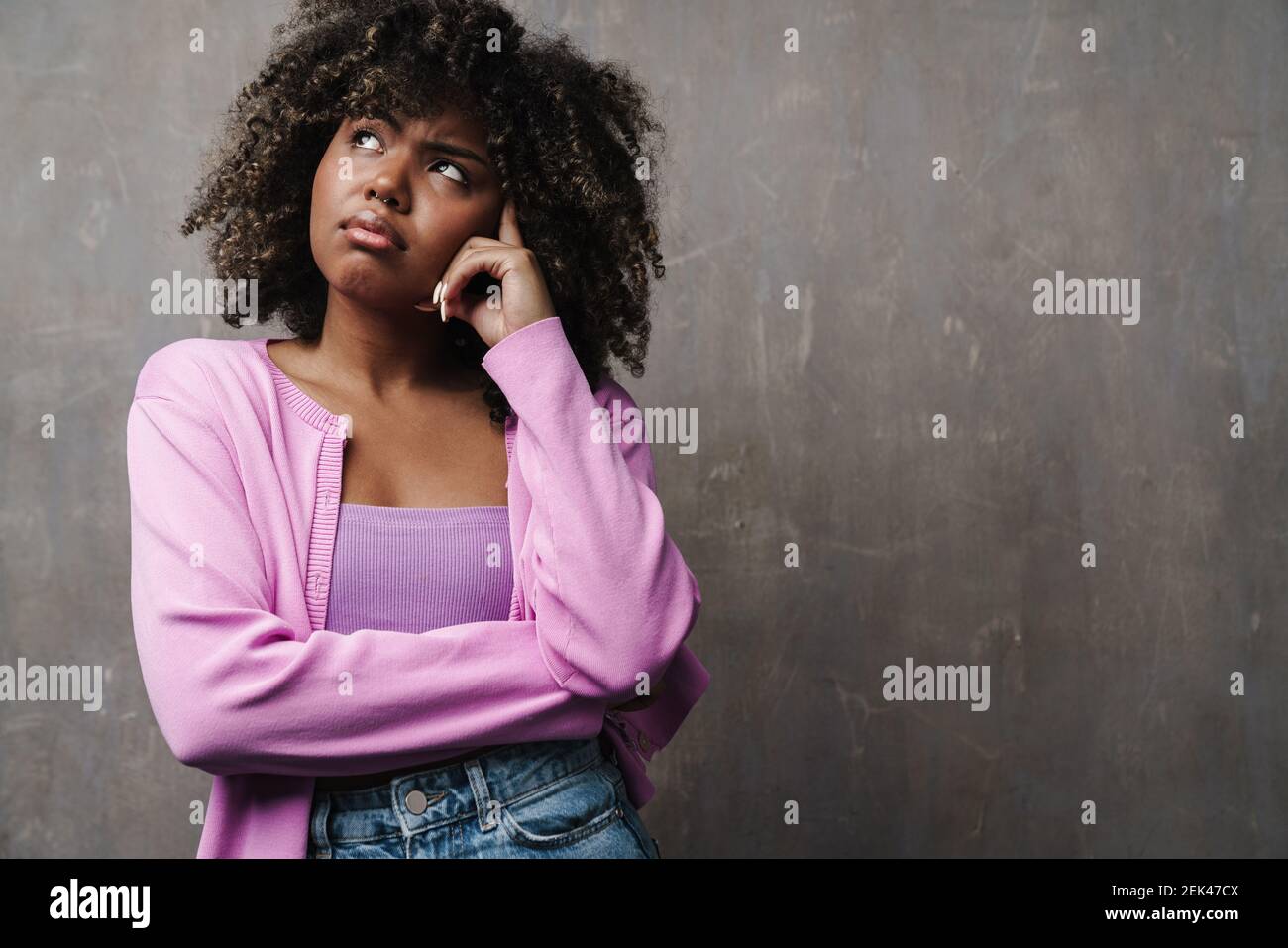 Thinking african american woman posing and looking upward isolated over ...