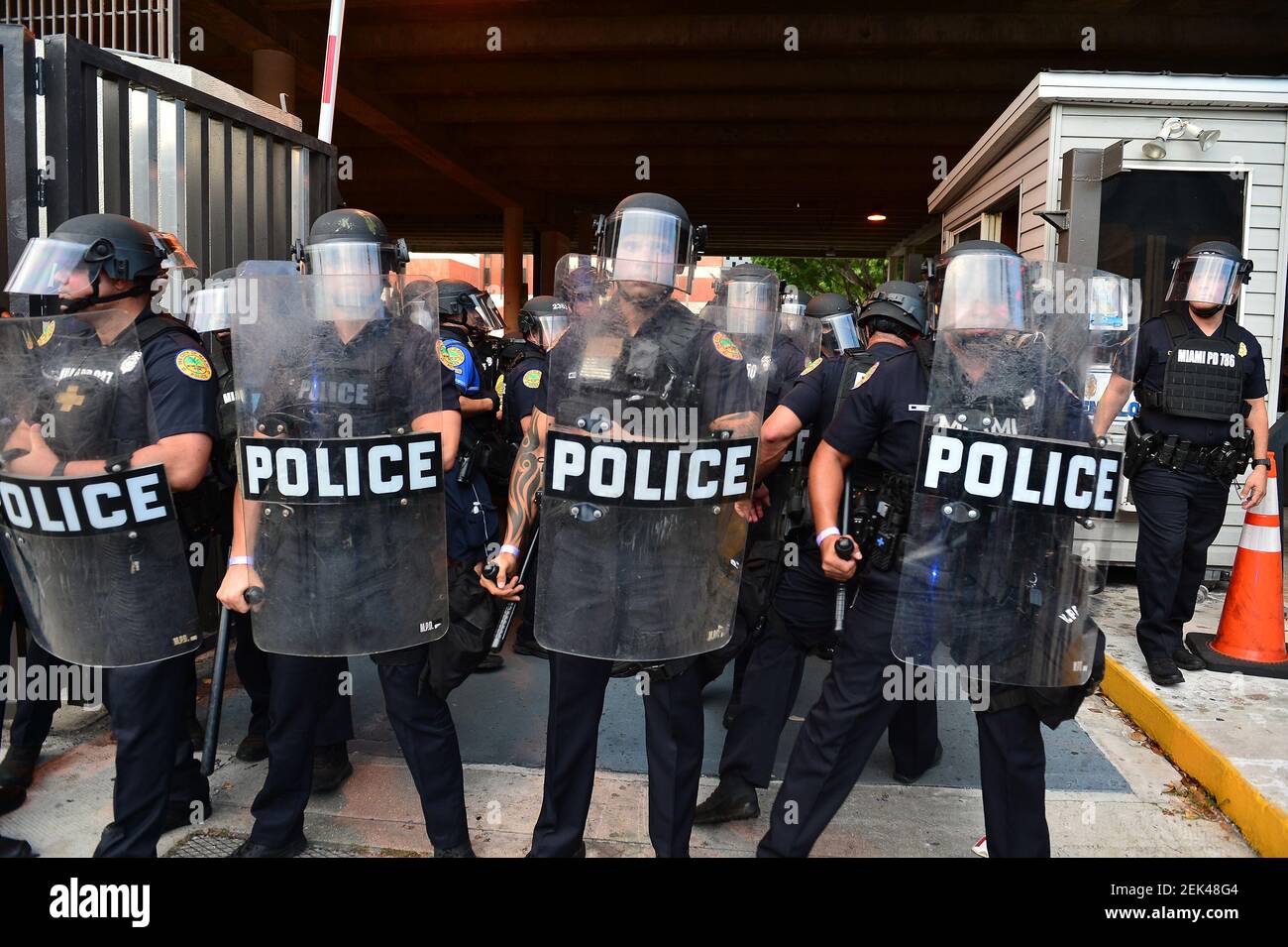 Miami Police officer in riot gear and shield confront protestor. Police