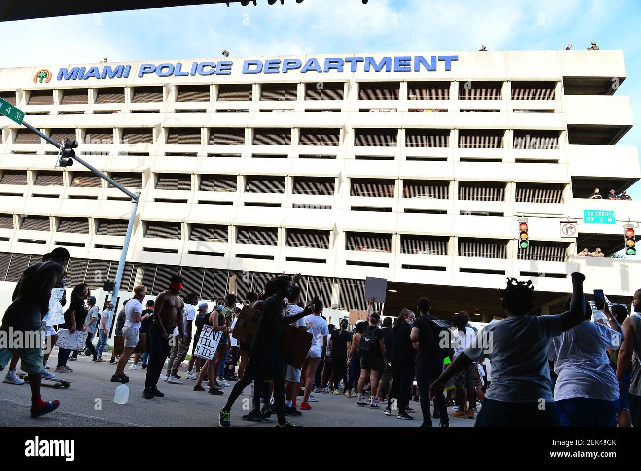 Protestor is seen holding up a sign as they confront Miami Police ...