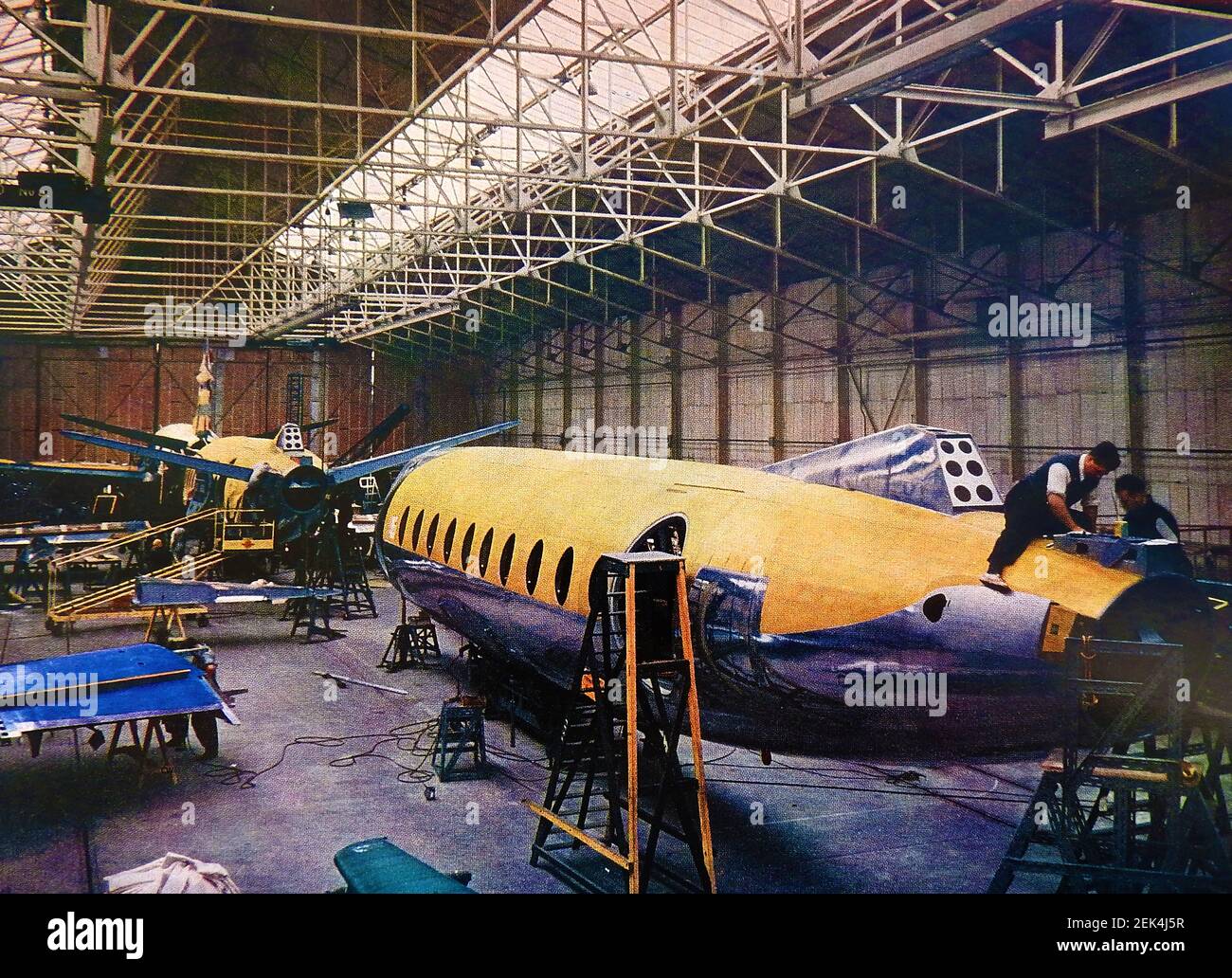An old  c1950 printed colour photograph showing Vickers Viscount passenger aircraft under construction at Hurn, Bournemouth, UK.  Vickers Armstrong moved into the hangars vacated by BOAC In 1950 and started production of Varsities.This was followed by Viscounts,and later,as the British Aircraft Corporation,production of the BAC-111. Stock Photo