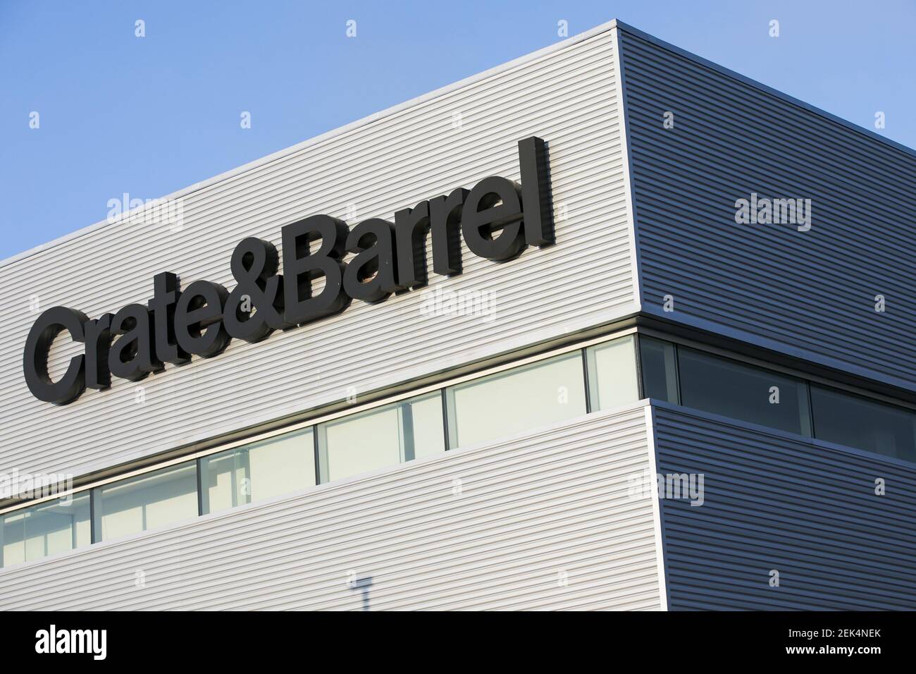 A logo sign outside of a Crate and Barrel retail store location in