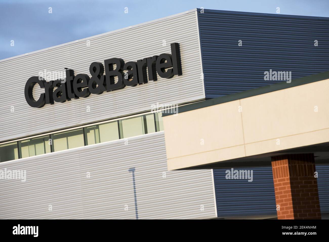 A logo sign outside of a Crate and Barrel retail store location in