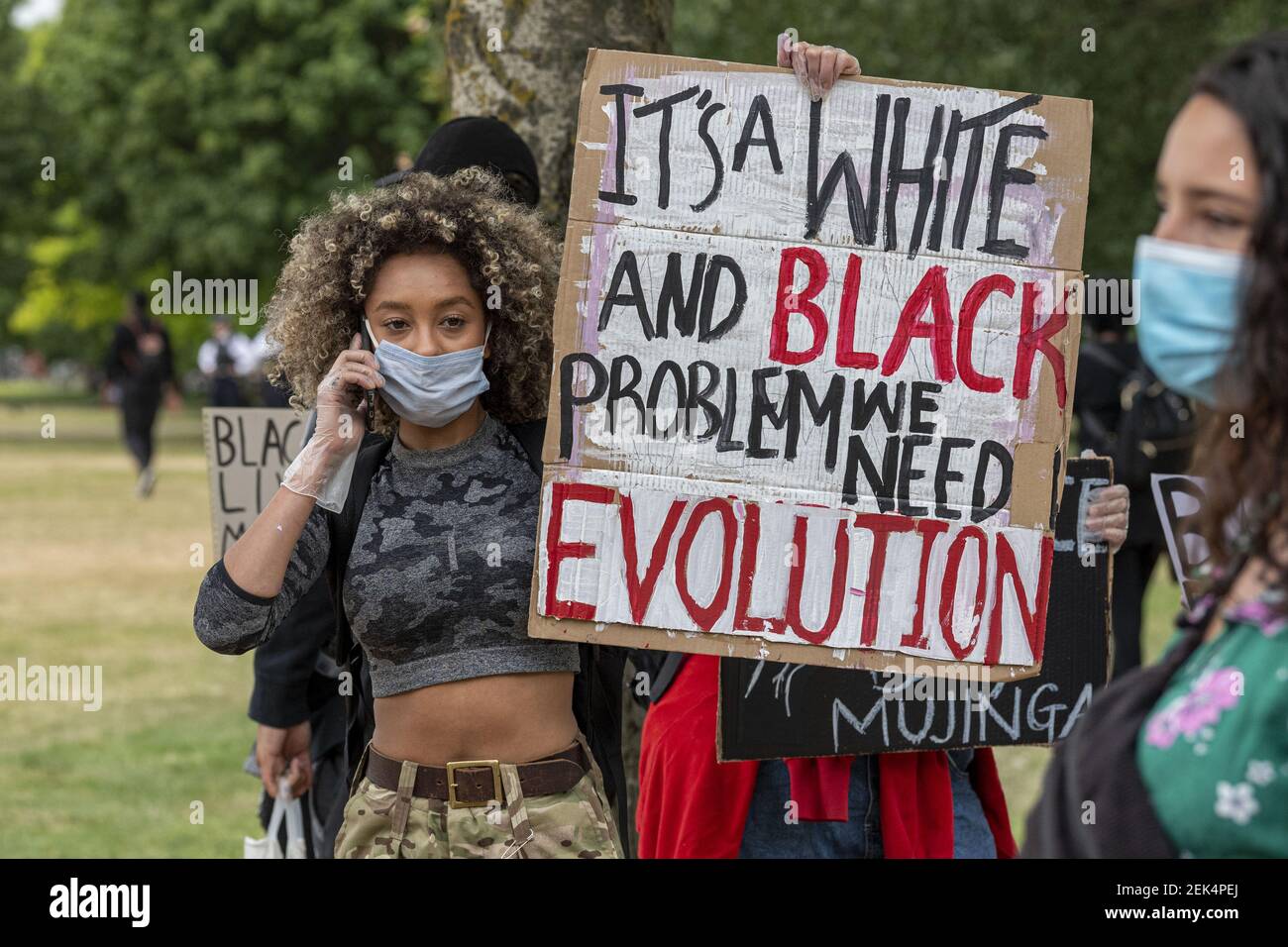 A protester holding a placard saying U.S. war machine: real threat to  peace at a rally against war with Russia sponsored by multiple groups  including CODEPINK: Women for Peace, Black Alliance for