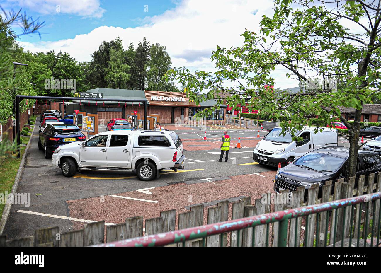 Customers are seen queuing at the drivethru to order meals. McDonald's