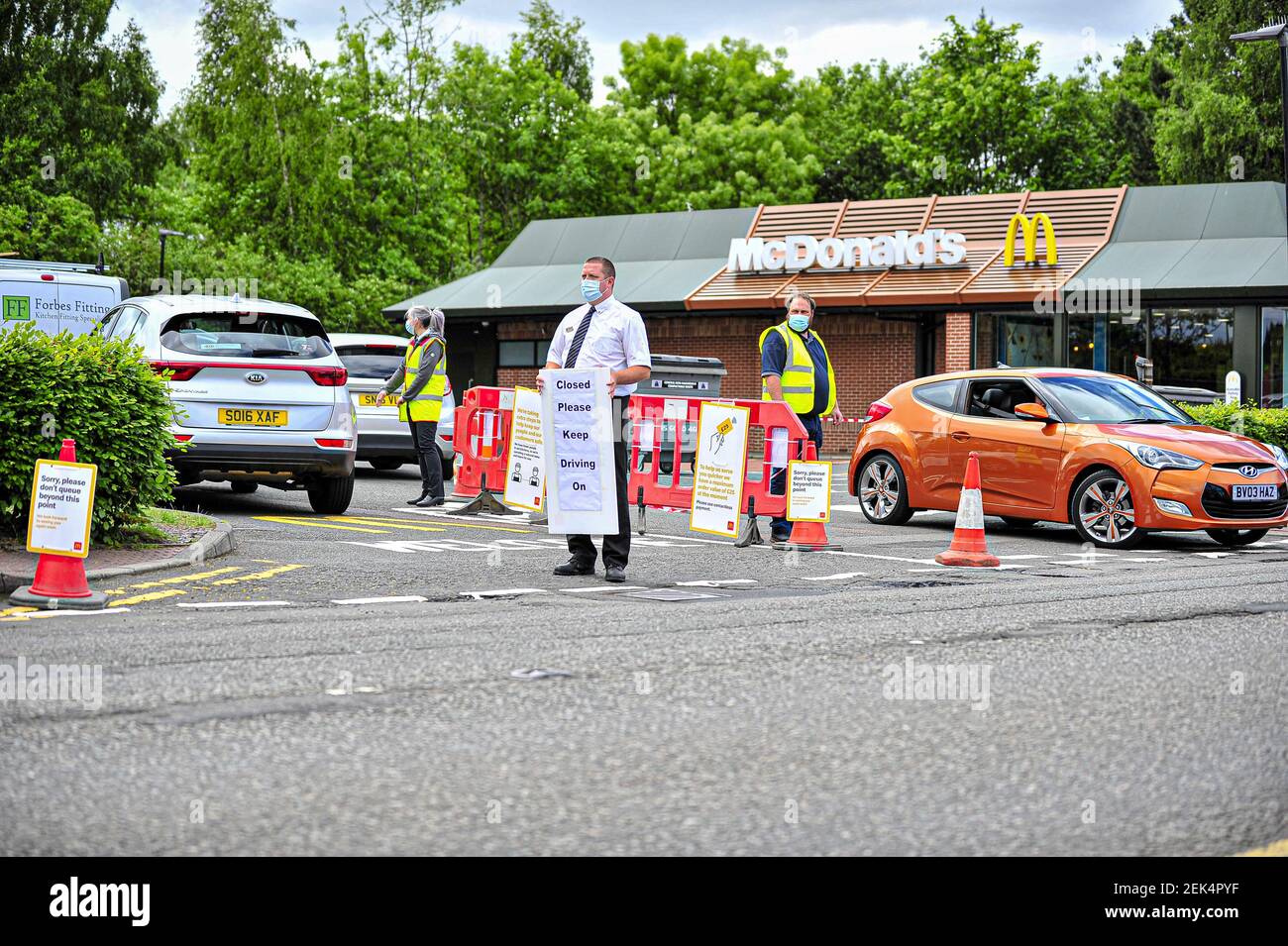 Manager of the branch holding a sign alerting motorists about the full