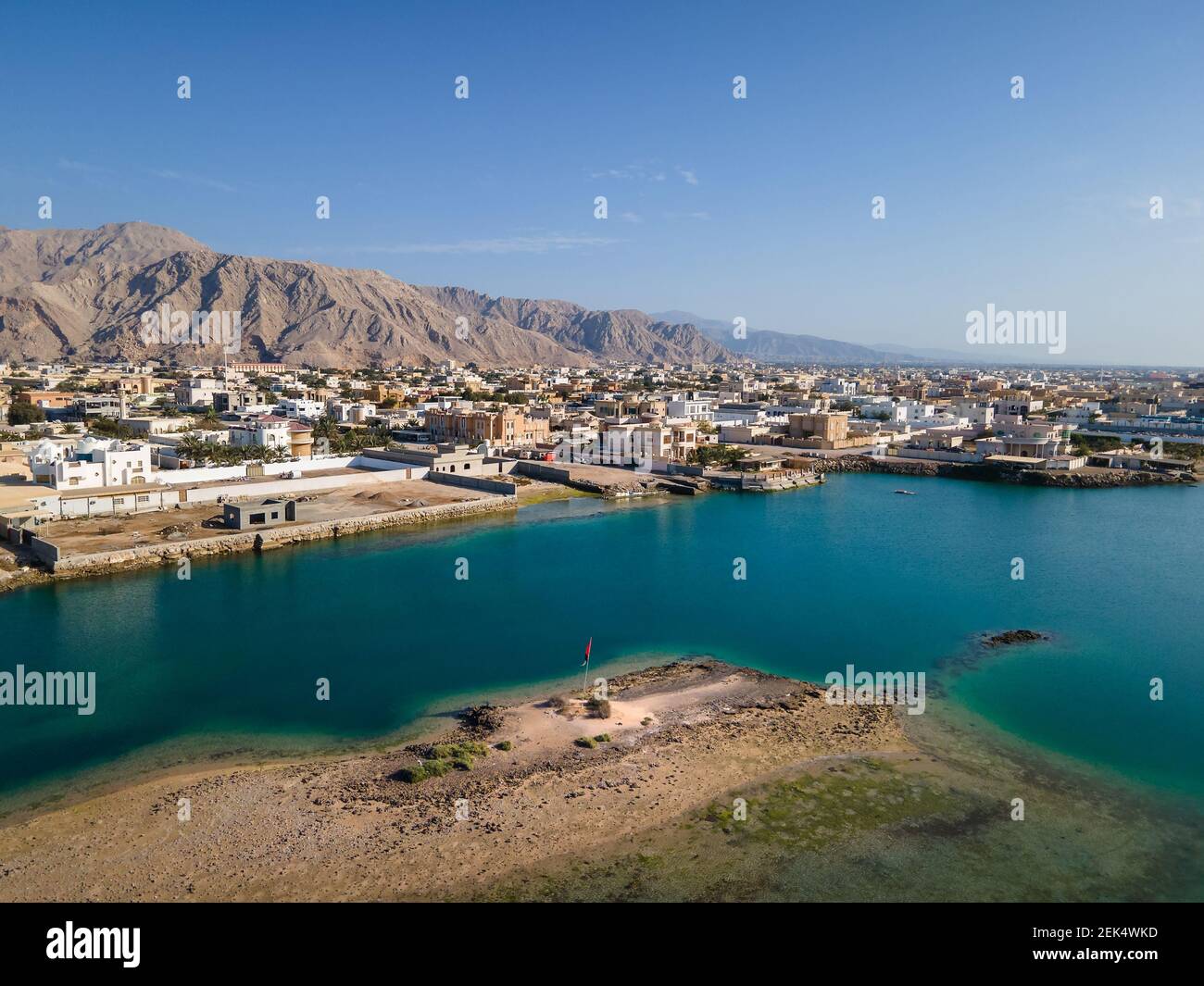 Al Rams county, the suburb of Ras Al Khaimah emirate in the United Arab Emirates settling bellow the sandstone mountains by the seaside aerial view Stock Photo