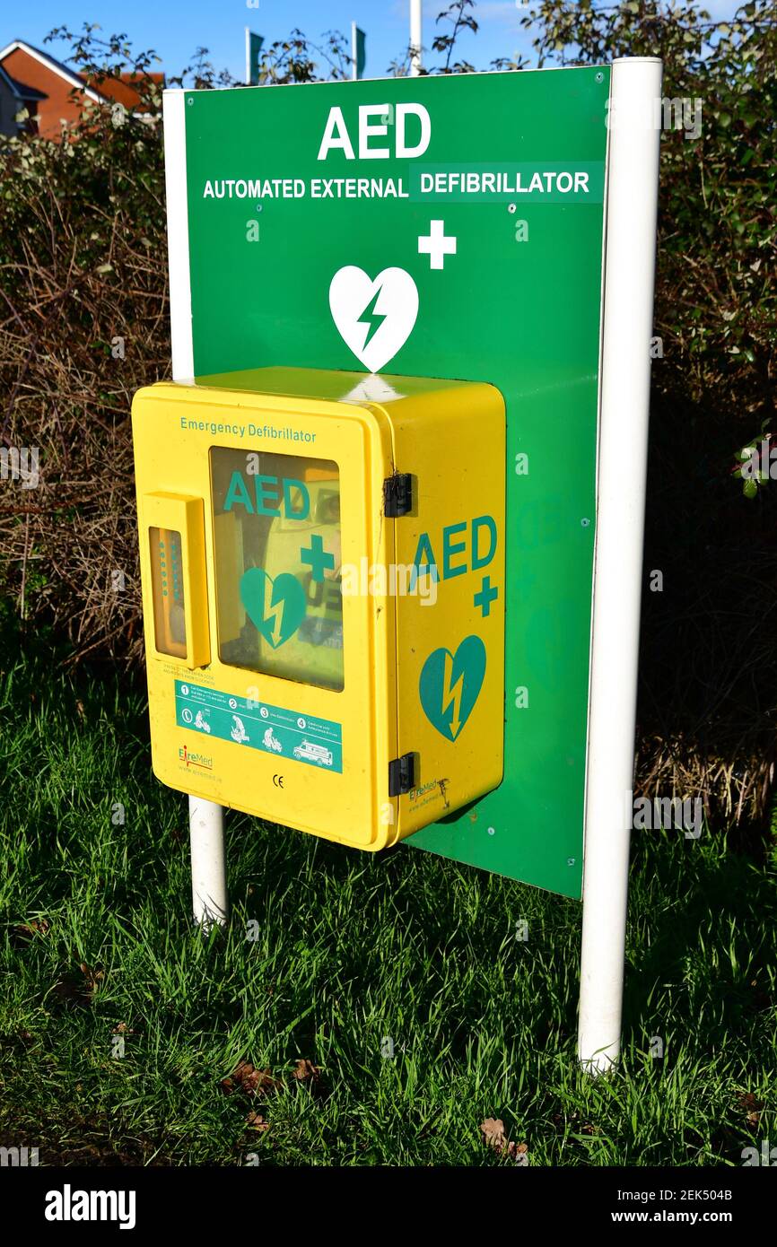 Automated External Defibrillator (AED) for the urgent treatment of a heart attack, positioned on grass verge, UK Stock Photo