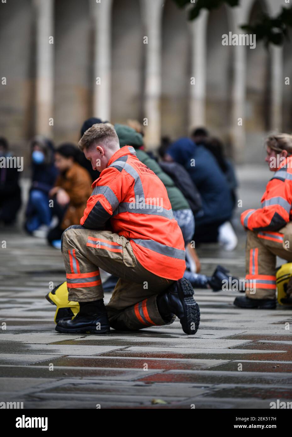 A member of the fire & rescue crew takes a knee during the demonstration. Hundreds of people together with the members of the Fire & Rescue service took to the streets in solidarity with the Black Lives Matter march following the killing of George Floyd, a black man who died in police custody in Minneapolis. (Photo by Kenny Brown / SOPA Images/Sipa USA)  Stock Photo