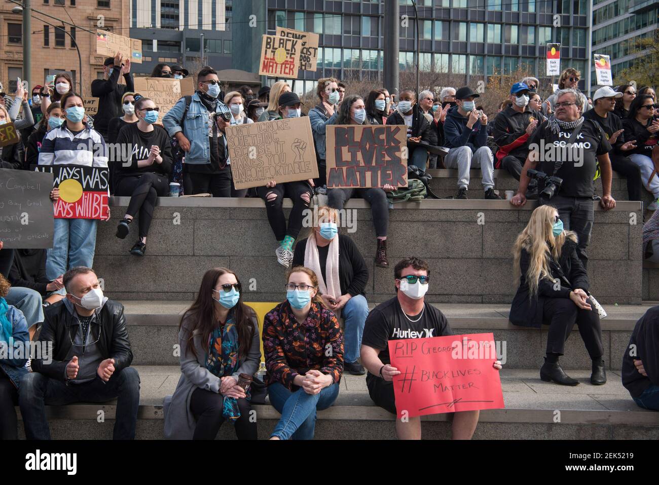 Protesters hold placards while wearing face masks during the demonstration. Thousands of