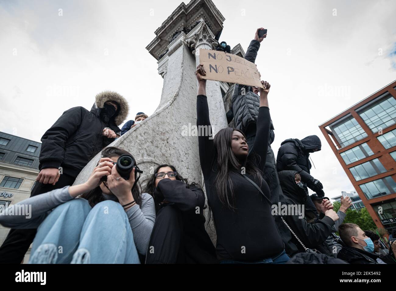 A protester holds a placard that says No Justice, No Peace during the demonstration. Thousands of people attend the most recent 'Black Lives Matter' protest in Manchester's city centre following the death of George Floyd in the USA. (Photo by Kenny Brown / SOPA Images/Sipa USA)  Stock Photo