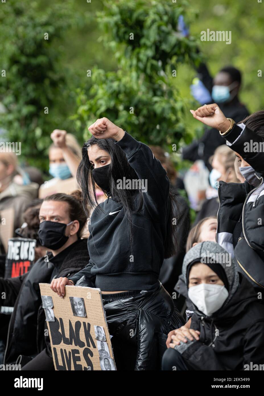 Protesters hold up their fists against racism during the demonstration. Thousands of people attend the most recent 'Black Lives Matter' protest in Manchester's city centre following the death of George Floyd in the USA. (Photo by Kenny Brown / SOPA Images/Sipa USA)  Stock Photo
