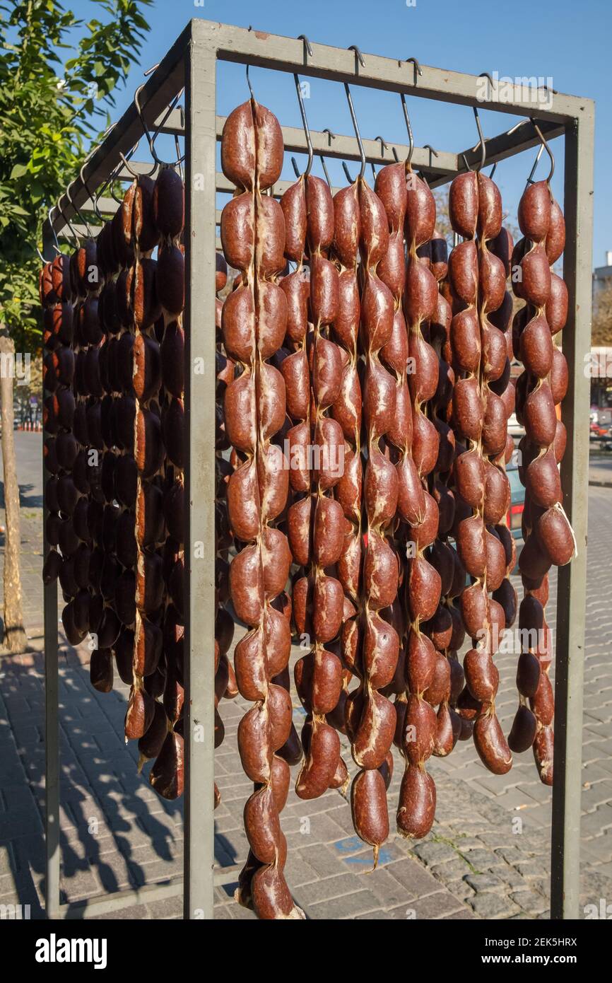 Smoked sausages hangs outdoor next to a butcher's shop to attract buyers in Turkey Stock Photo