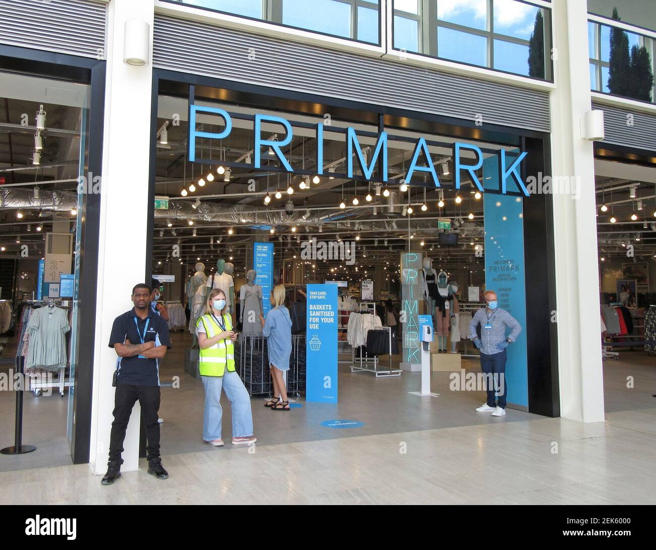 Security and staff with face masks wait at the entrance to direct customers  to the Primark store. Non essential shops were reopened today in both the  'Intu Shopping Centre' and the 'centre:mk'