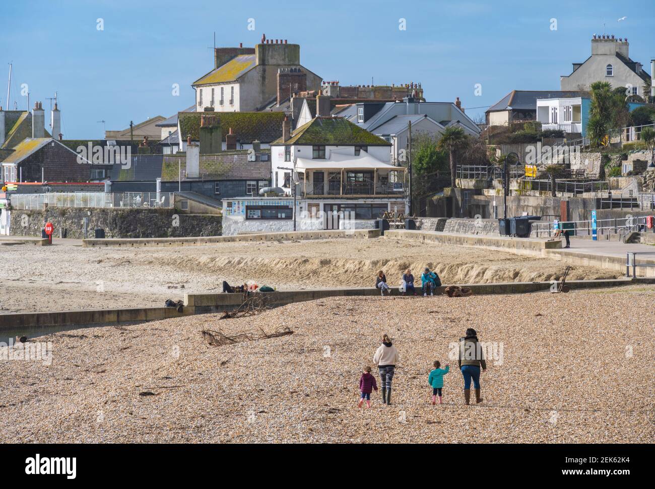 Lyme Regis, Dorset, UK. 23rd Feb, 2021. UK Weather: Locals enjoy the spring sunshine and bright blue skies on a breezy morning at Lyme Regis. Businesses in the town are looking forward to the gradual lifting of the lockdown in time for the summer season. Credit: Celia McMahon/Alamy Live News Stock Photo