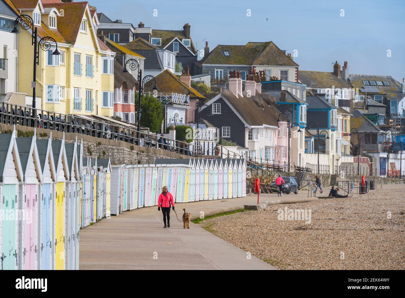 Lyme Regis, Dorset, UK. 23rd Feb, 2021. UK Weather: Locals enjoy the spring sunshine and bright blue skies on a breezy morning at Lyme Regis. Businesses in the town are looking forward to the gradual lifting of the lockdown in time for the summer season. Credit: Celia McMahon/Alamy Live News Stock Photo