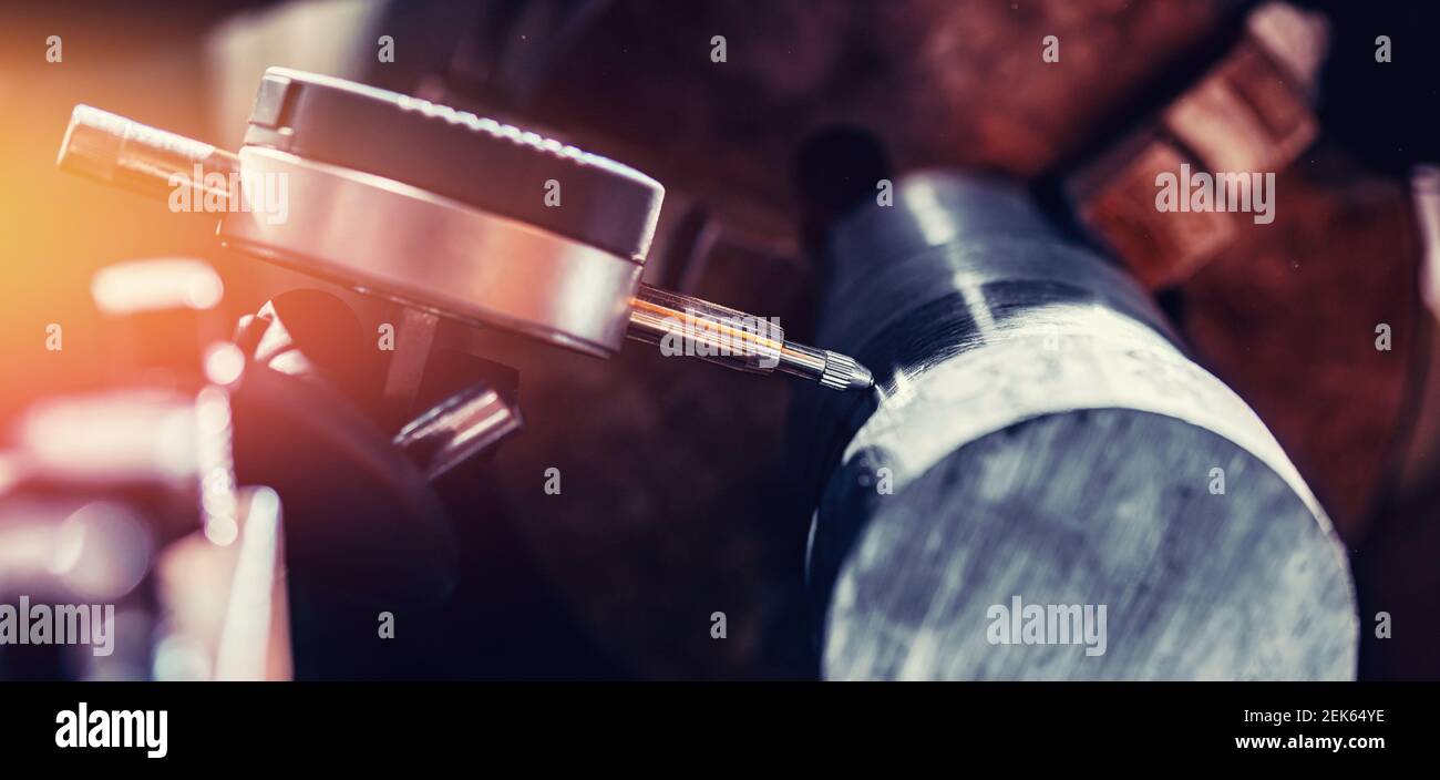 Operator measures vibration of workpiece steel ingots. Process CNC