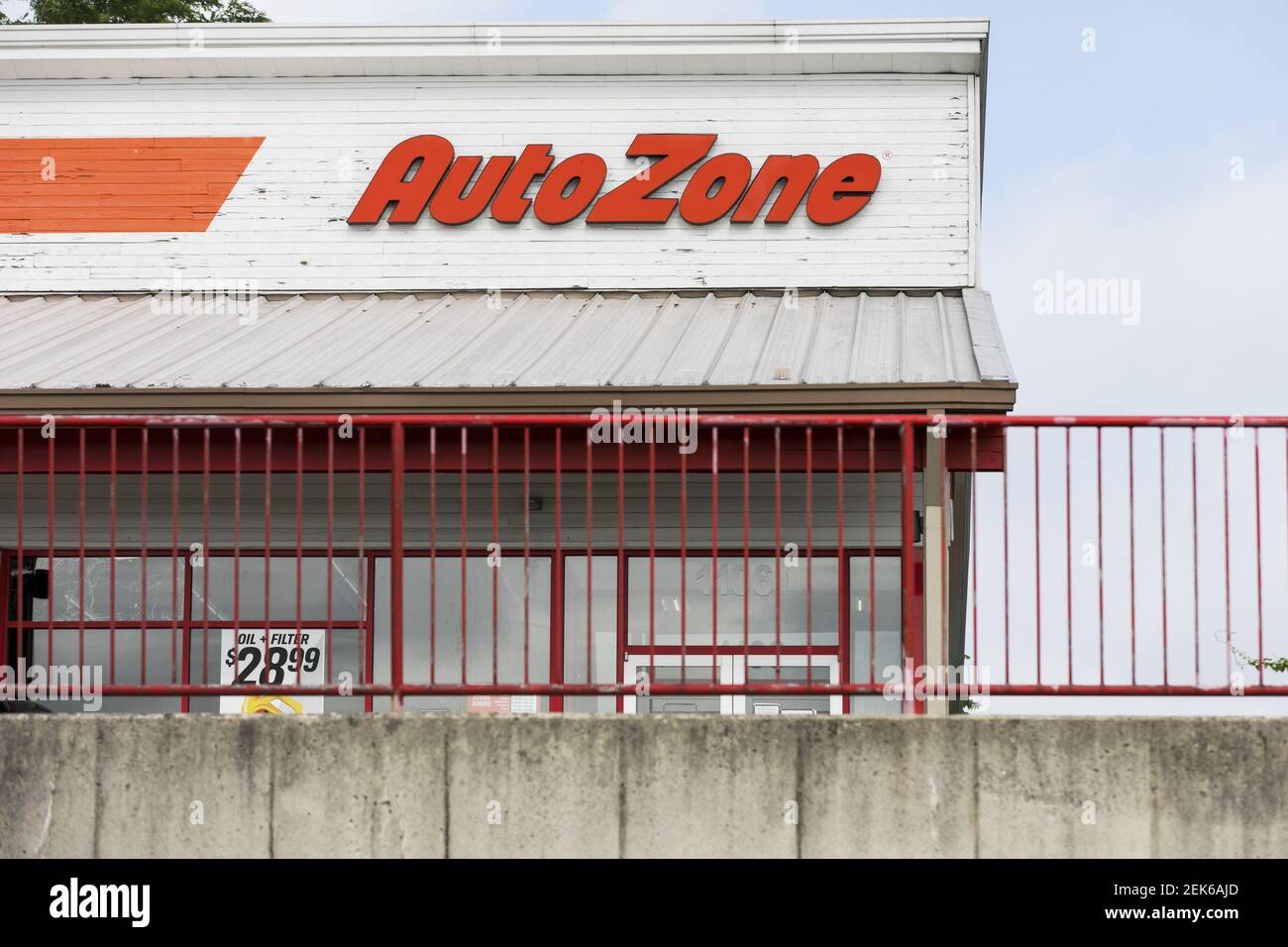 A logo sign outside of a AutoZone retail store location in Frederick