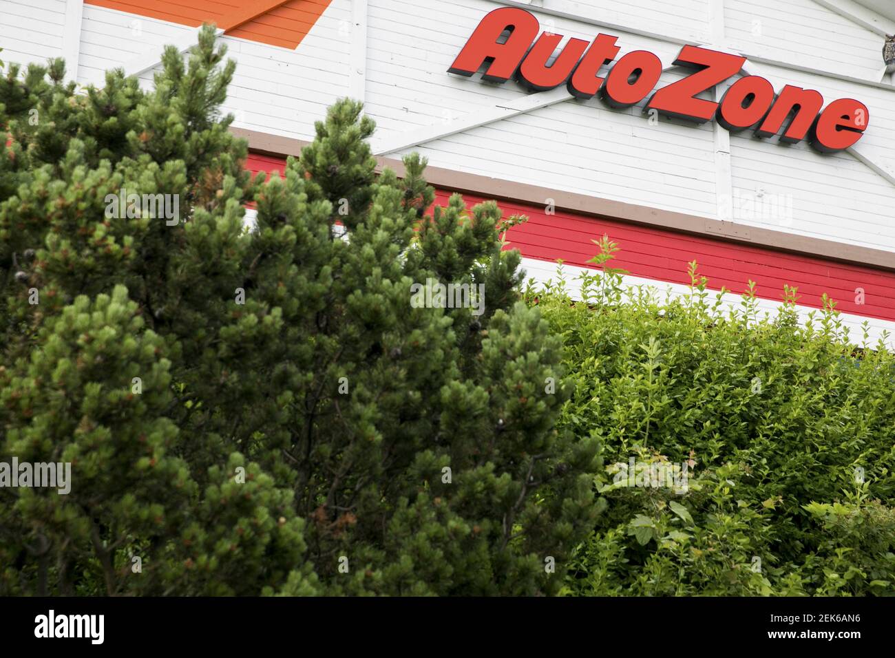 A logo sign outside of a AutoZone retail store location in Frederick