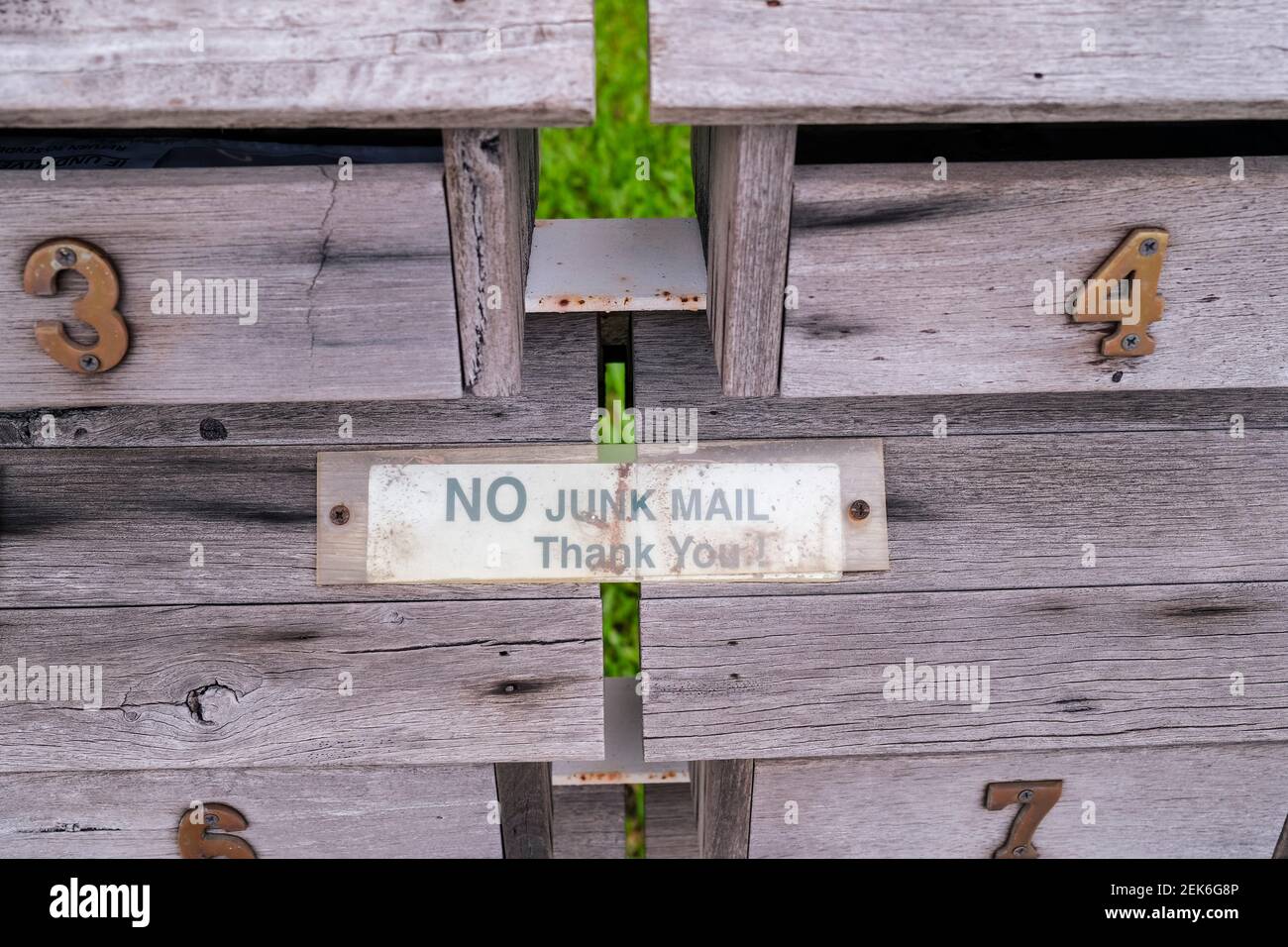 No Junk Mail sign on old wooden mailboxes Stock Photo