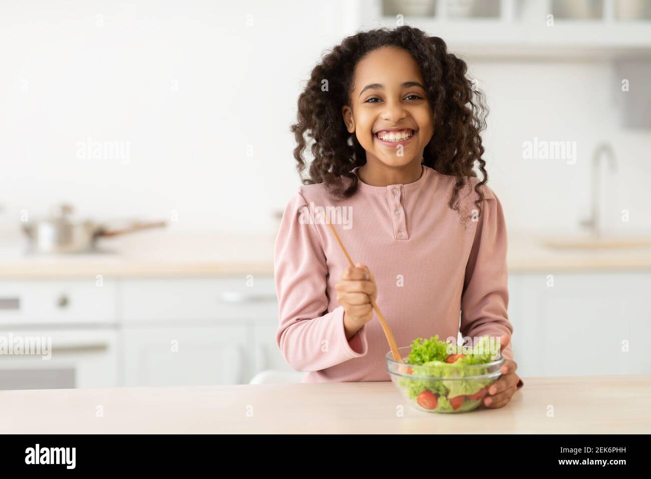 https://c8.alamy.com/comp/2EK6PHH/cheerful-african-american-girl-preparing-healthy-salad-2EK6PHH.jpg