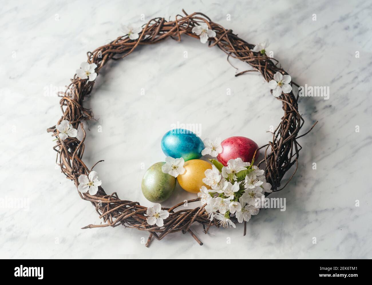 Happy Easter greeting card with Easter wreath, dyed eggs and spring ...