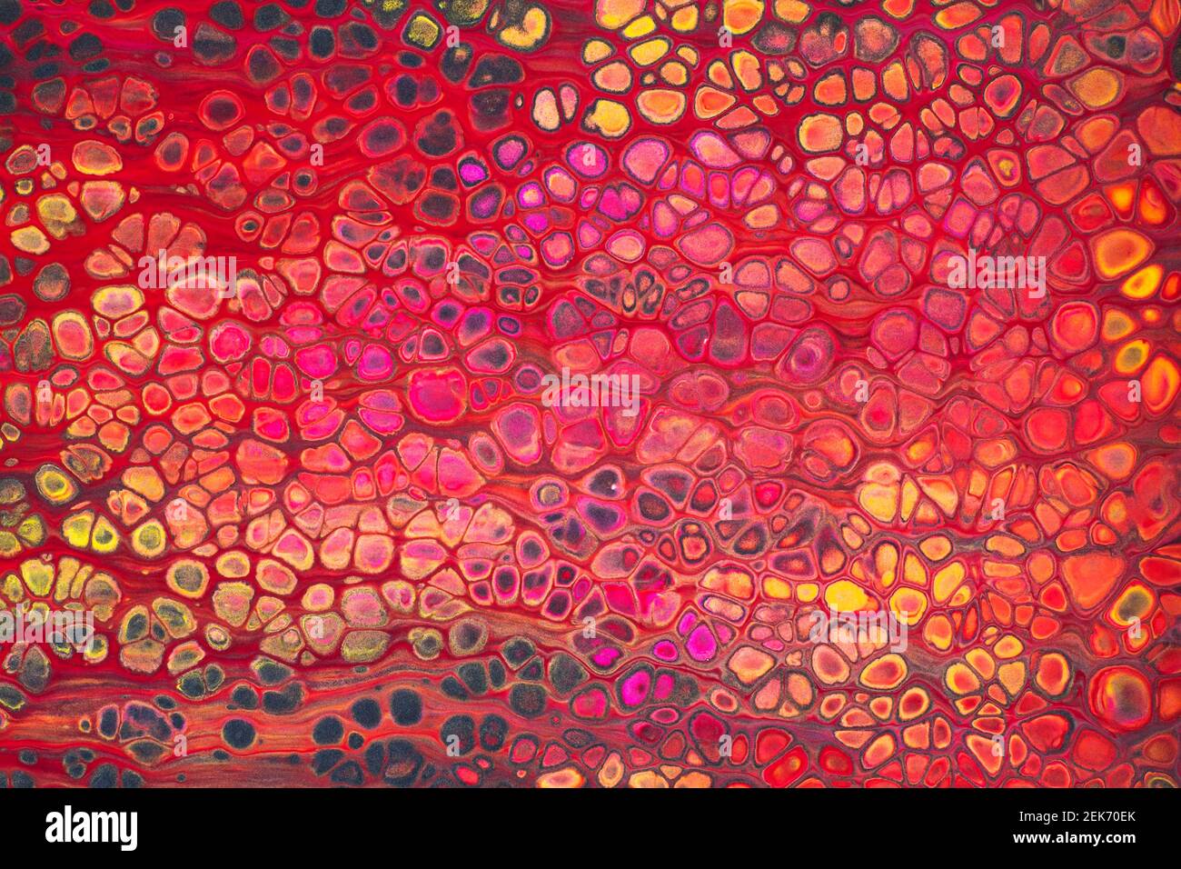 Colorful abstract acrylic painting in red and yellow. Free flowing cells. Pouring. Stock Photo