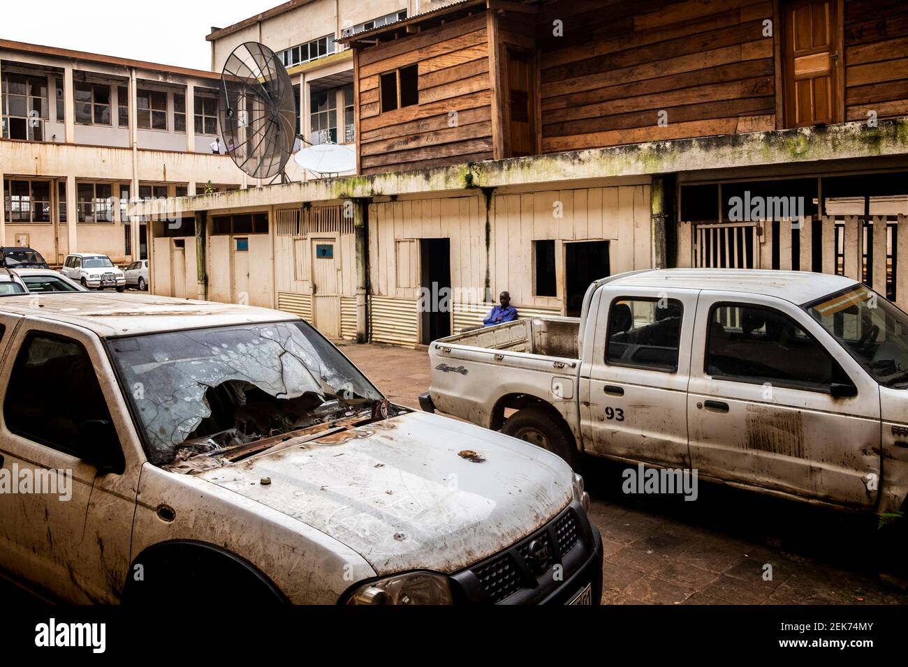 In the car parking of the local radio of Goma, some cars damaged during a conflict with bandits. North Kivu, DRC Stock Photo