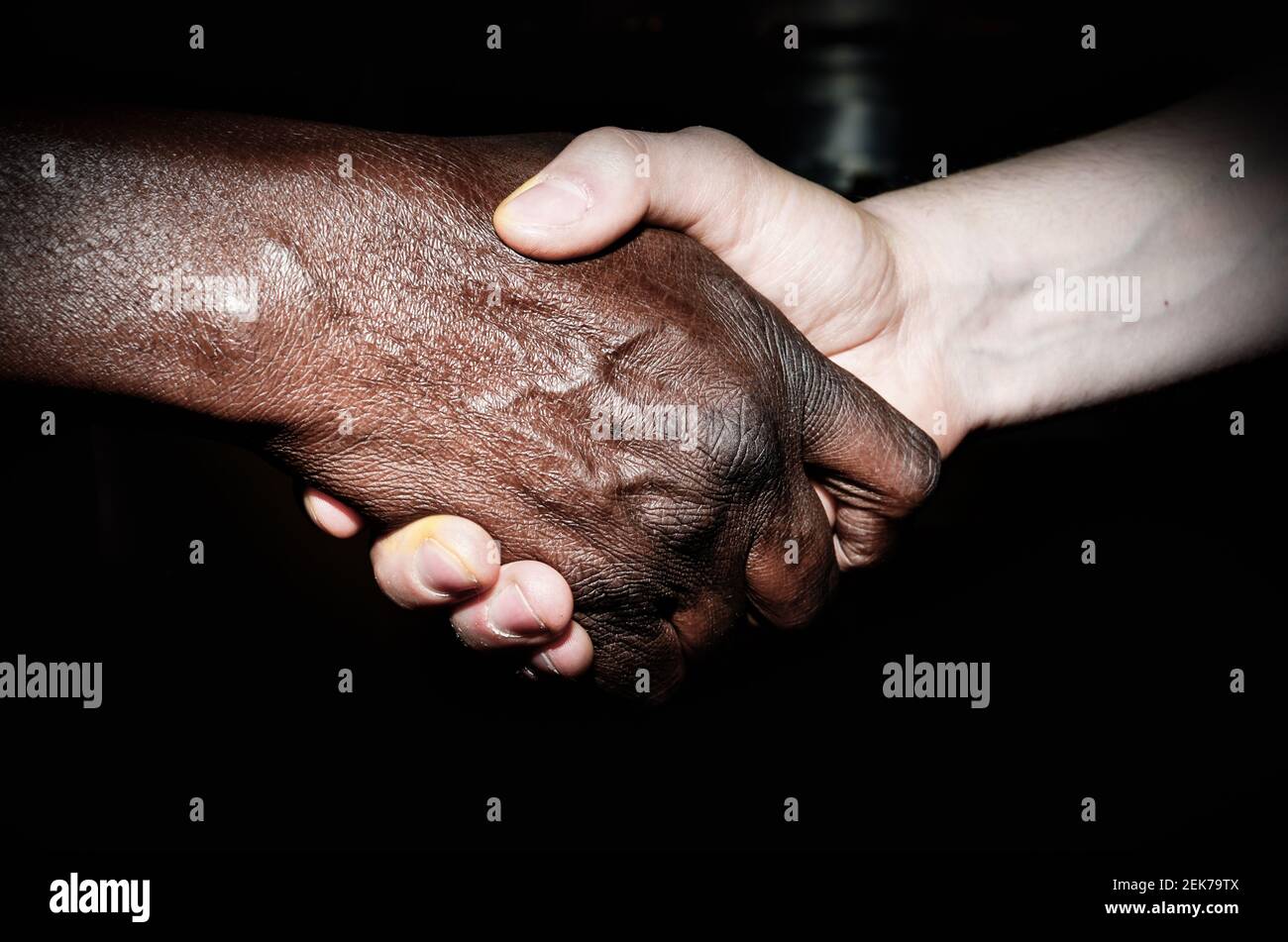 Handshake between an African and a European Stock Photo