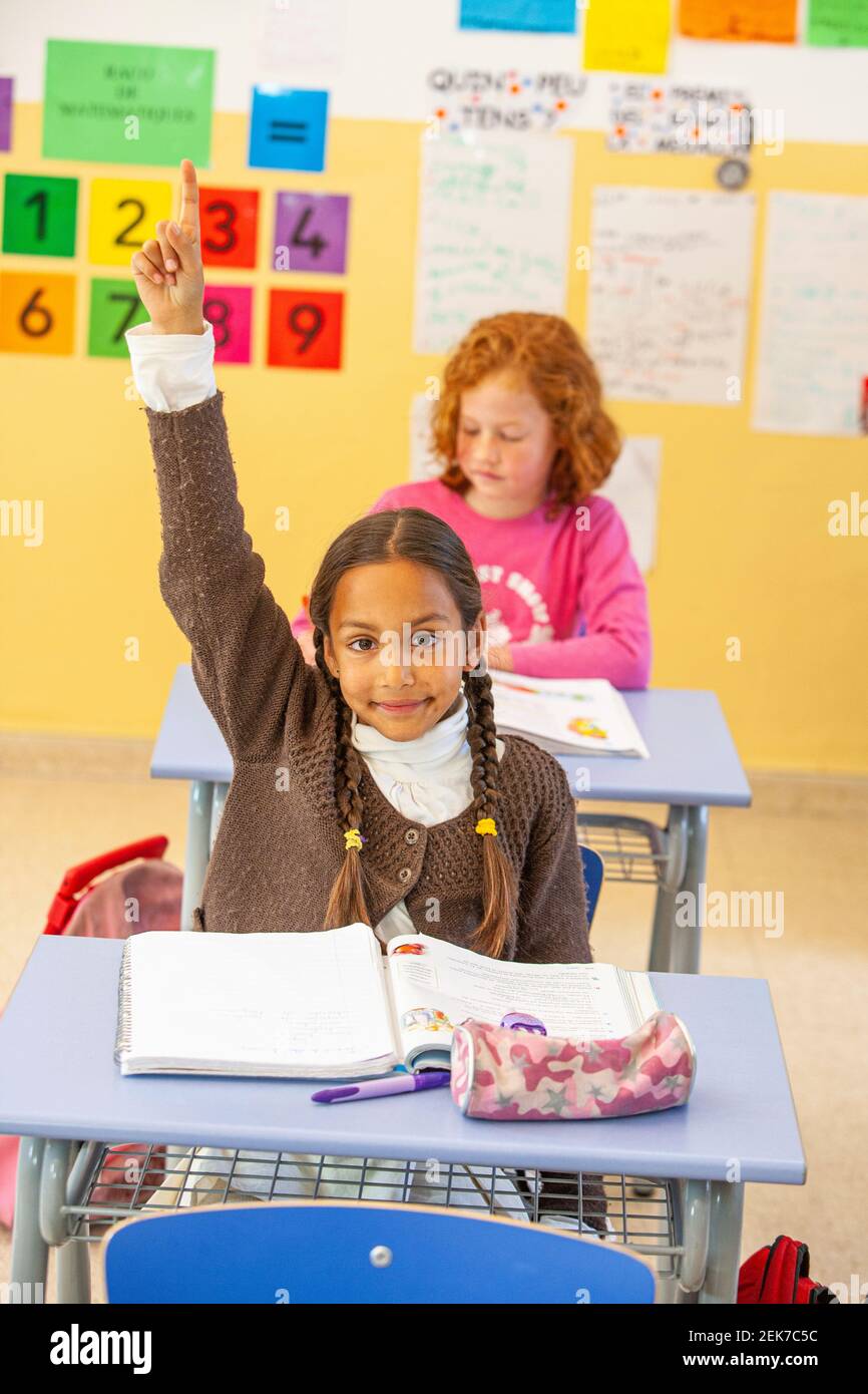 Young girl looking to camera in a school classroom Stock Photo - Alamy