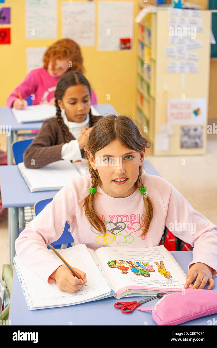 Young girl looking to camera in a school classroom Stock Photo - Alamy